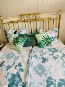 a bed with blue and white sheets and pillows at Casa Wellness am Wald 140 qm Bed & Breakfast & Wellness in Mörlenbach