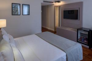 Cama ou camas em um quarto em Bourbon Hotel & Suites Curitiba