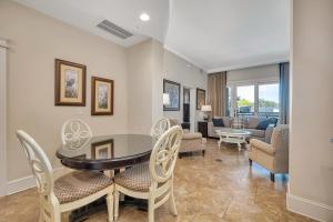 a dining room with a table and chairs at Sea Gate #205 in Demere Park