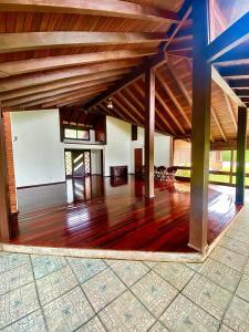 a large room with wooden floors and a wooden ceiling at Casa de Campo - Espaço Garden in Novo Hamburgo +18 photos