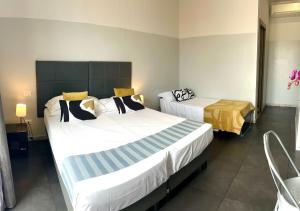 A bed or beds in a room at Floor 6 Boutique Rooms by DOT Suites