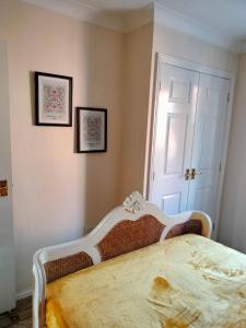 a bedroom with a bed and two pictures on the wall at Canalside Chic Your London Escape Starts Here WIFI and Airport Transfers in Hemel Hempstead