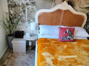 a bedroom with a bed with a white bed frame at Canalside Chic Your London Escape Starts Here WIFI and Airport Transfers in Hemel Hempstead