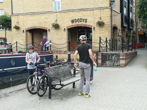 a man and a woman standing next to a bench and a bike at Canalside Chic Your London Escape Starts Here WIFI and Airport Transfers in Hemel Hempstead