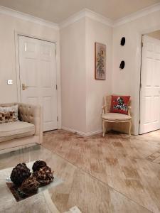 a living room with a couch and a chair at Canalside Chic Your London Escape Starts Here WIFI and Airport Transfers in Hemel Hempstead