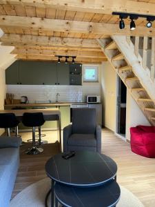 a living room with a table and a kitchen at Evergreen Tiny Homes in Peje