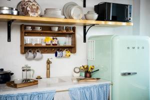 a kitchen with a sink and a refrigerator at Cinema & Gaming House with View in Skotina