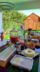a table topped with lots of food on top at Pousada La Belle de Jour in Majorlândia