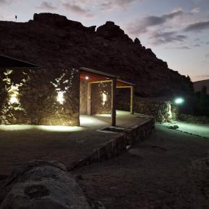 a stone house lit up at night with lights at Alto Jere in Toconao
