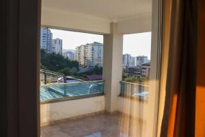 a room with a balcony with a view of a city at BAHAR RESIDENCE in Trabzon