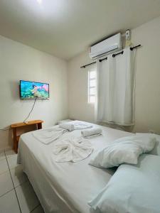 Postel nebo postele na pokoji v ubytování Casa Temporada Suítes + 36 fotografií