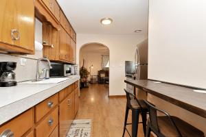 een keuken met houten kasten en een aanrechtblad bij Spacious 3bdr near 6Flags-Naval Base-Casino in Waukegan