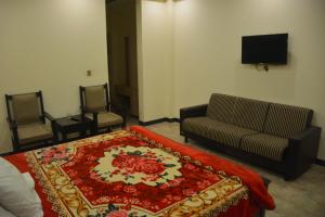 a living room with a couch and a bed and a tv at Hotel Rock Star, Naran in Naran +25 photos