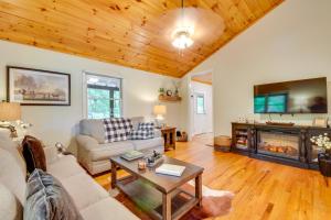 a living room with a couch and a fireplace at 6 Miles to Helen Cabin with Hot Tub and Views! in Clarkesville