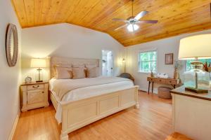 a bedroom with a bed and a ceiling fan at 6 Miles to Helen Cabin with Hot Tub and Views! in Clarkesville