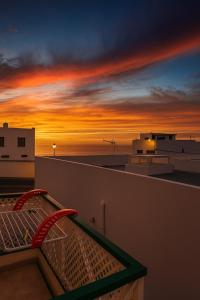 a view of the sunset from the balcony of a building at Casa Brisa in La Santa