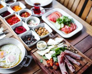 a table topped with trays of different types of food at Bodrum Eskiçeşme Lumy Hotel - Private Pool in Bodrum City +13 photos