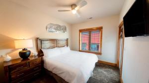 a bedroom with a white bed and a window at The Boiler - 3-Bedroom, 3-Bathroom Penthouse Suite at REAL Watersports in Waves