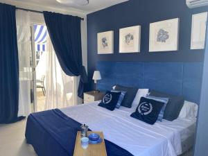 a blue bedroom with a bed with blue walls at Malibu Park Apartment Mar Azul in Adeje