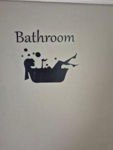 a book with a picture of a bath tub with the words bathroom at Au petit bonheur in Hautefage-la-Tour +33 photos
