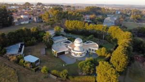 布罗塔斯Brotas Eco Hotel Fazenda的从空中俯瞰一座大型建筑物，旁边放着一台望远镜。