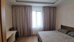 a bedroom with a bed and a window at Chic 3-room apartment in K'obulet'i
