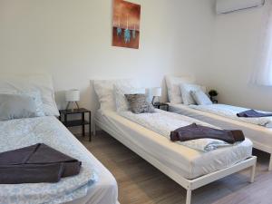 a room with two beds and a couch at Vitorlásház in Balatonvilágos