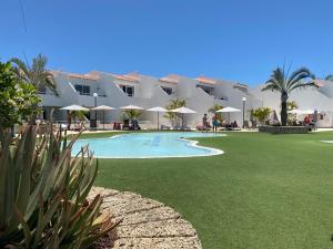 a resort with a swimming pool and a resort at Malibu Park Apartment Mar Azul in Adeje
