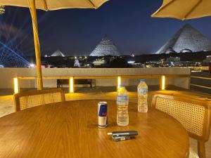a wooden table with two bottles of water on it at Pyramids Top view inn in Cairo
