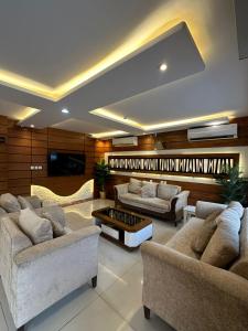 a living room with couches and a flat screen tv at ركن الرفاهية للشقق المخدومة- اقتصادي in Riyadh