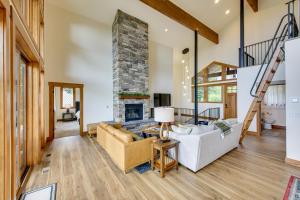 a living room with a fireplace and a couch at Ski-InandSki-Out Schweitzer Mtn Home Decks and Views! in Sandpoint