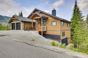 a house on a hill with a driveway at Ski-InandSki-Out Schweitzer Mtn Home Decks and Views! in Sandpoint