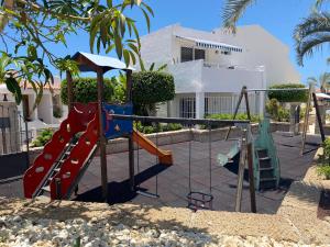 a playground with a slide and a swing set at Malibu Park Apartment Mar Azul in Adeje