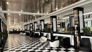 a lobby with a checkered floor and a waiting room at Hotel Puerto Palace in Puerto de la Cruz