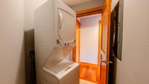 a white washer and dryer in a room at The Cove - 3-Bedroom, 3-Bathroom Penthouse Suite at REAL Watersports in Waves +31 photos