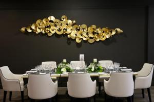 a dining room with a table with white chairs at Hotel Puerto Palace in Puerto de la Cruz