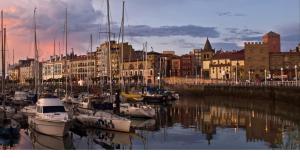 a group of boats are docked in a harbor at Casa Yayi in Luanco