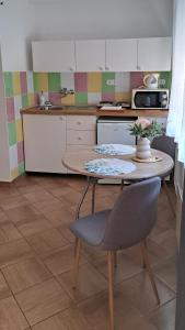 a kitchen with a table and a table and chairs at Anna's House in Bük
