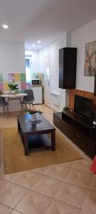 a living room with a coffee table and a flat screen tv at Anna's House in Bük
