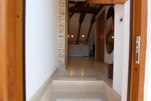 a hallway with a tile floor and a brick wall at Dubrovnik Rupe Apartment in Dubrovnik