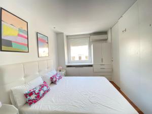 a bedroom with a white bed with two pillows on it at Apartamento Plaza España in Madrid