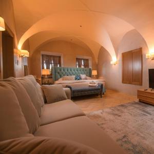 a living room with a bed and a couch at Vila Zipser in Poprad