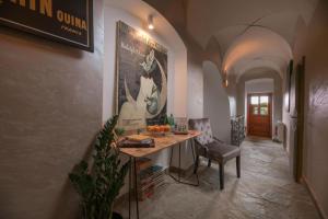 a hallway with a table and a chair in a room at Vila Zipser in Poprad