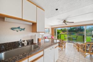 a kitchen with a sink and a counter top at Prince Kuhio 115 in Kipu