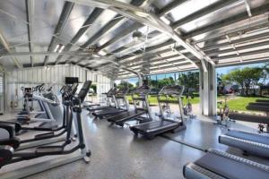 a gym with rows of treadmills and cardio machines at Prince Kuhio 115 in Kipu