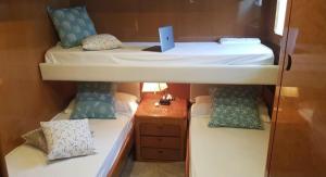 a small room with two bunk beds and a table at La Giorgia Boat in Lacco Ameno
