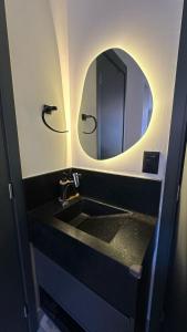 a bathroom with a sink and a mirror at Get Sense Beira Mar in João Pessoa