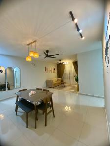 a living room with a table and a couch at EJ HomeStay Sireh Residence Apartment in Kota Bharu