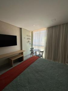 a hotel room with a large bed and a table at Get Sense Beira Mar in João Pessoa +40 photos