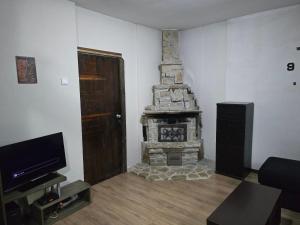 a living room with a fireplace and a television at NANNY Home sweet in Bijela
